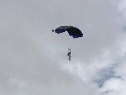 A paraglider drifts through the sky. Stock Footage