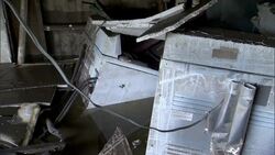 A washer and dryer are surrounded by debris in a flooded basement. Stock Footage