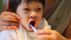 HD:Mom is helping son brush his teeth Stock Footage