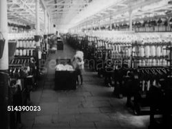 1949: INDIA COTTON MILL: HA WS Cotton Mills. TU 'The Tata Mills, Ltd.' sign. VS Cotton Mill workers unloading raw cotton, Indian women operating spinning machines, male workers behind machine, material moving through rollers, worker pulling cloth down Instructional Video
