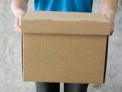 Delivery man holding a cardboard box. Stock Footage