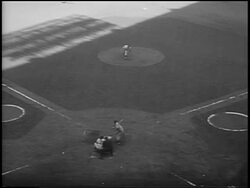 B/W 1956 high angle Don Larsen pitching a 'perfect game' with Dale Mitchell trying to hit + missing ball during Game 5 of the World Series Stock Footage