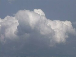 Cotton wool clouds against blue sky from aircraft window, CU, Europe Stock Footage