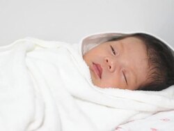 Sleeping baby wrapped in white blanket Stock Footage