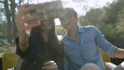 Two young women take selfie and laugh in backseat of classic Ford Bronco Stock Footage