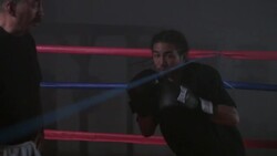 A boxer bobs and weaves under a rope as his trainer looks on. Stock Footage