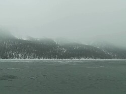 mountain lake changing seasons from late winter to early spring Stock Footage