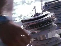 Locked off shot of rope being wound around a winch then with attaching a handle above it is wound further by rotating the crank Stock Footage