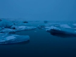 MS T/L PAN View of moving float glaciers on Jokulsarlon lake at dawn / Ireland Stock Footage
