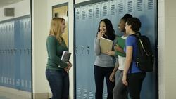 Young adult females bullying another student at school Stock Footage