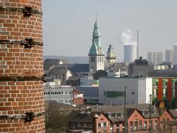 WS View from World Cultural Heritage Site Volklingen Ironworks (Volklinger Hutte) of cathedral and industrial site / Volklingen, Saarland, Germany Stock Footage