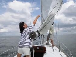 couple put main sail up on yacht /tampa,florida,USA Stock Footage