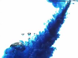 Blue ink falling into water against white background, Slow motion Stock Footage