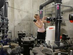 Technical expert woman in plant underground room arranging small meter Stock Footage