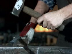 HD Super Slow-Mo: Blacksmith Hammering A Metal Stock Footage