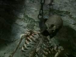 CU Skeleton chained to dungeon wall by metal neck collar with shadows on wall / Gwydir Castle, Wales, UK Stock Footage