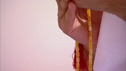 Hands hold a decorated Koran and prayer beads. Stock Footage