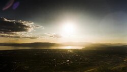 The sun sets over a quiet, populated valley. Stock Footage