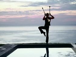 MS TU ZI Male poi dancer performing in front of pool with reflection of his silhouette in pool at sunrise / Montezuma, Costa Rica Stock Footage