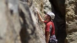 A young man rock climbing on a mountain. Stock Footage