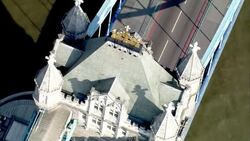 Pedestrians and vehicles travel across the Tower Bridge over the River Thames. Stock Footage