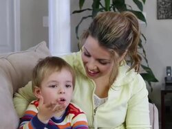 Mother and son watching TV Stock Footage