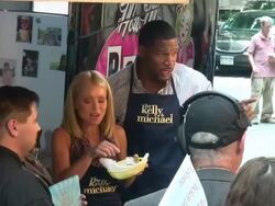 Kelly Ripa and Michael Strahan eating their wraped chicken on the outside set of the Live with Kelly & Michael show in New York, NY, on 7/11/13. (Getty Images Entertainment Video) Stock Footage