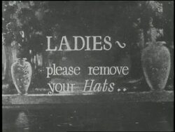 A title card reads Ladies, please remove your hats. Stock Footage