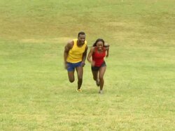 Playful Male and Female Athletes Run Up Hill Stock Footage