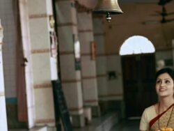 Woman ringing bell of a temple  Stock Footage