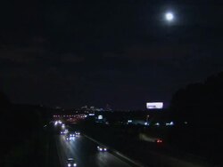 HA Headlights of cars driving on divided highway with full moon shining above / Columbia, South Carolina, United States Stock Footage