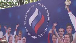 Olympic fans next to 'Team Russia' banner News Clip