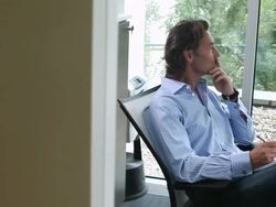 MS ZO Pensive businessman writing in notebook and  keeping feet on table  / Brussels , Brabant, Belgium Stock Footage