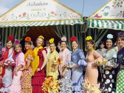 MS CU Group of women in traditional Sevillana dress posing and waving in front of a casita tented building / Seville, Andalusia, Spain Stock Footage