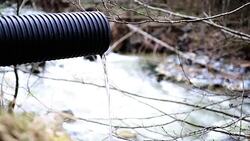 Industrial pipe polluting the natural water resources Stock Footage