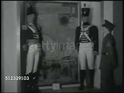 1942: U.S. MARINES MUSEUM: UNIFORMS: WS Marines looking at long row of various uniform displays. VS Mannequins in uniform from First Barbary War (AKA 'Leathernecks') in Tripoli display. CU Mannequin in European uniform. Washington D.C. Instructional Video