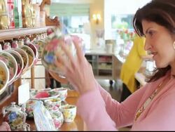 CU Customer examining flowered teapot in store / Los Angeles, California, United States Stock Footage