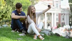 Man with book and girl with smartphone. Stock Footage