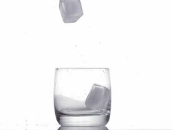 Three Ice Cubes falling into Glass against White background, Slow motion Stock Footage