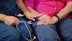 Home healthcare nurse comforts senior woman. Hands. Stock Footage
