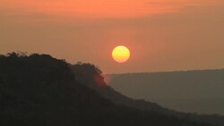 Sunrise through flowing cloud waves, mountain Stock Footage