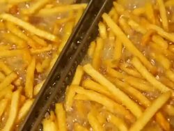 Fast Food French Fries in Restaurant Deep Fryer Stock Footage