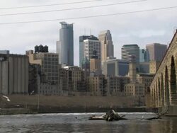 The skyline of Minneapolis Minnesota as seen from under the Stone Arch Bridge  Stock Footage