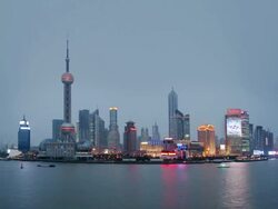 Time lapse long shot Pudong skyline (view across Huangpu River from the Bund) / dusk to night / Shanghai Stock Footage