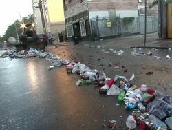 Medium Shot - Garbage truck sweeping trash down the street / New Orleans Louisiana Stock Footage