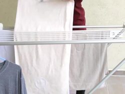 Housewife hanging up laundry Stock Footage