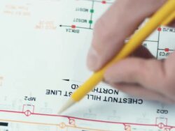 HD CRANE: Reading blueprints and schematics Stock Footage