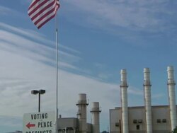 November 2, 2010 TD Voters walk past American flag after casting ballots / Dearborn, Michigan, united States Stock Footage