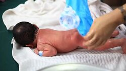 Footage of the one-day-old newborn baby showers Stock Footage