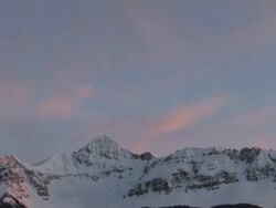 MS T/L View of Clouds and Snow Rolling over Majestic Mountain Peaks in evening Light / Telluride, Colorado, United States Stock Footage